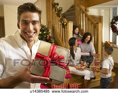 Hispanic family exchanging gifts at Christmas View Large Photo Image Stock Photography - Hispanic family exchanging gifts at Christmas. Fotosearch