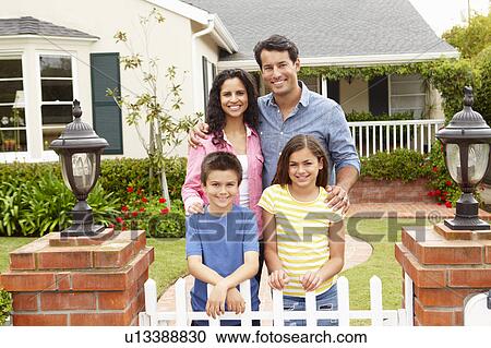 Stock Image - Hispanic family outside home. Fotosearch