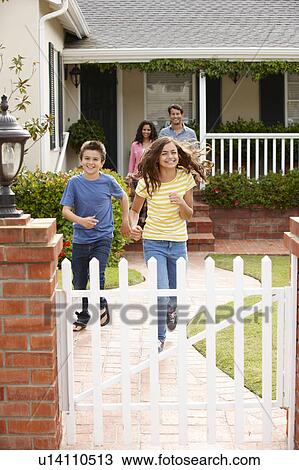 Stock Image - Hispanic family outside home. Fotosearch