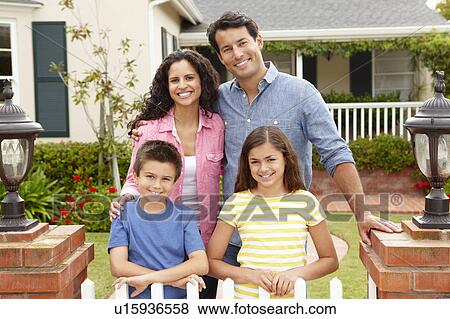 Stock Photo - Hispanic family outside home. Fotosearch