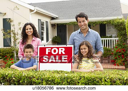 Hispanic family outside home with for sale sign View Large Photo Image Stock Photograph - Hispanic family outside home with for sale sign. Fotosearch