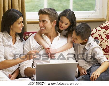 Picture - Hispanic family shopping online. Fotosearch