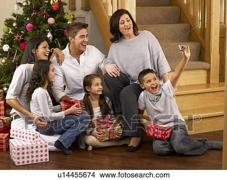 Hispanic family taking photos at Christmas View Large Photo Image Picture - Hispanic family taking photos at Christmas. Fotosearch