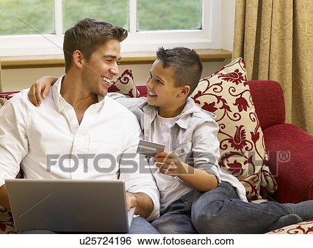 Hispanic father and son shopping online View Large Photo Image Stock Photograph - Hispanic father and son shopping online. Fotosearch