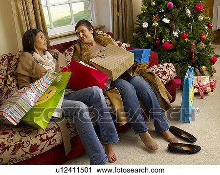 Hispanic mother and daughter resting after Christmas shopping View Large Photo Image Stock Image - Hispanic mother and daughter resting after Christmas shopping. Fotosearch