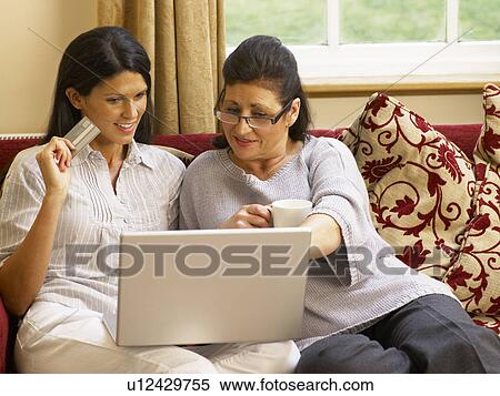 Hispanic mother and daughter shopping online View Large Photo Image Stock Photography - Hispanic mother and daughter shopping online. Fotosearch