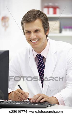 Picture - Hospital doctor at desk. Fotosearch