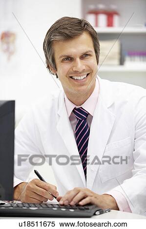 Stock Photography - Hospital doctor at desk. Fotosearch