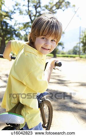 Little boy on country bike ride View Large Photo Image Stock Image - Little boy on country bike ride. Fotosearch