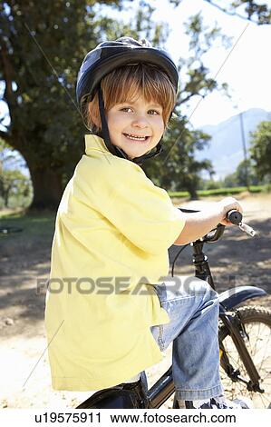 Stock Image - Little boy on country bike ride. Fotosearch