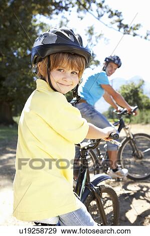 Little boy on country bike ride with dad View Large Photo Image Stock Photo - Little boy on country bike ride with dad. Fotosearch