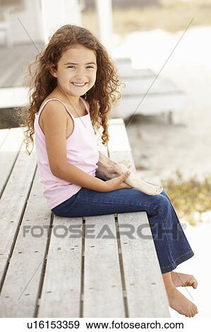 Little girl outdoors holding starfish View Large Photo Image Stock Photo - Little girl outdoors holding starfish. Fotosearch