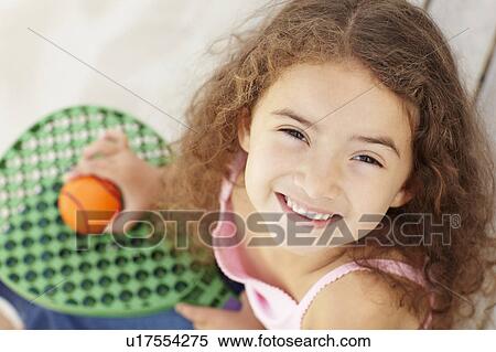 Stock Photography - Little girl outdoors with bat and ball. Fotosearch