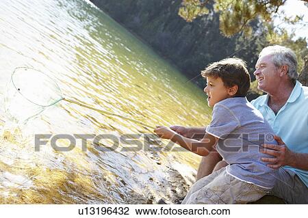 Man and boy fishing together View Large Photo Image Stock Image - Man and boy fishing together. Fotosearch