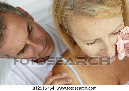 Man comforting crying wife View Large Photo Image Picture - Man comforting crying wife. Fotosearch