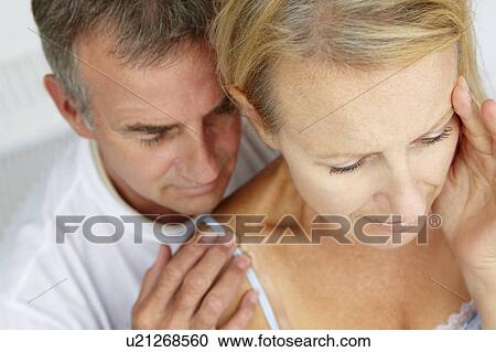 Stock Image - Man comforting distressed wife. Fotosearch