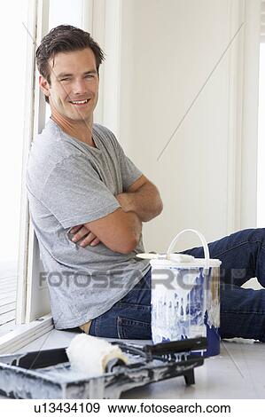 Stock Photo - Man decorating house. Fotosearch