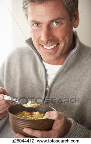 Man eating bowl of soup View Large Photo Image Stock Image - Man eating bowl of soup. Fotosearch