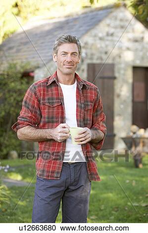 Man in country garden View Large Photo Image Stock Image - Man in country garden. Fotosearch