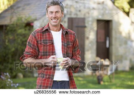 Man in country garden View Large Photo Image Stock Photograph - Man in country garden. Fotosearch