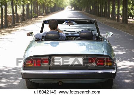 Stock Photo - Man in sports car. Fotosearch