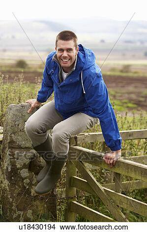 Man jumping over country gate View Large Photo Image Picture - Man jumping over country gate. Fotosearch