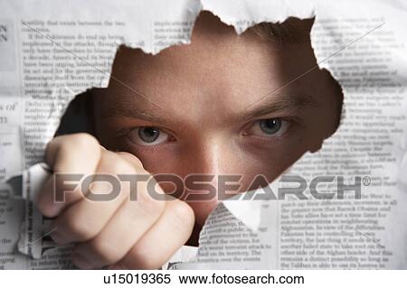 Man looking through hole in newspaper View Large Photo Image Stock Photography - Man looking through hole in newspaper. Fotosearch