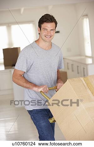 Man moving into new home View Large Photo Image Picture - Man moving into new home. Fotosearch