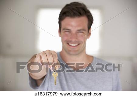 Stock Photo - Man moving into new home. Fotosearch
