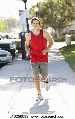 Stock Image - Man running on city street. Fotosearch