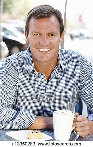 Man sitting at sidewalk café View Large Photo Image Stock Image - Man sitting at sidewalk café. Fotosearch