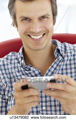Stock Image - Man texting. Fotosearch
