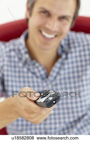 Man with remote control View Large Photo Image Stock Photo - Man with remote control. Fotosearch