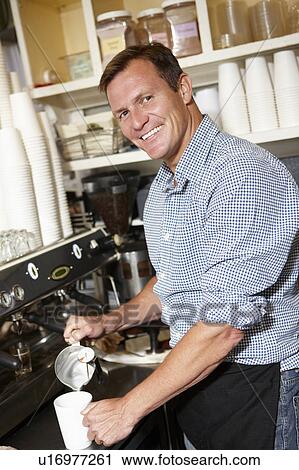 Man working in coffee shop View Large Photo Image Stock Image - Man working in coffee shop. Fotosearch