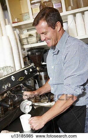 Man working in coffee shop View Large Photo Image Stock Photography - Man working in coffee shop. Fotosearch
