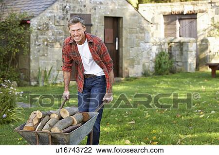 Stock Image - Man working in country garden. Fotosearch