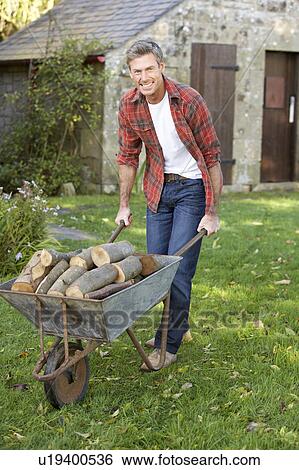 Man working in country garden View Large Photo Image Stock Photograph - Man working in country garden. Fotosearch