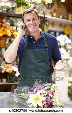 Man working in florist View Large Photo Image Stock Photograph - Man working in florist. Fotosearch