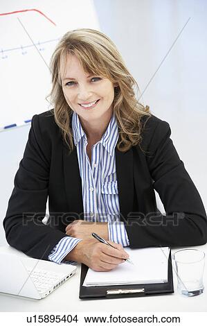 Mid age businesswoman at work View Large Photo Image Picture - Mid age businesswoman at work. Fotosearch