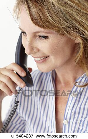 Mid age businesswoman on phone View Large Photo Image Stock Photo - Mid age businesswoman on phone. Fotosearch