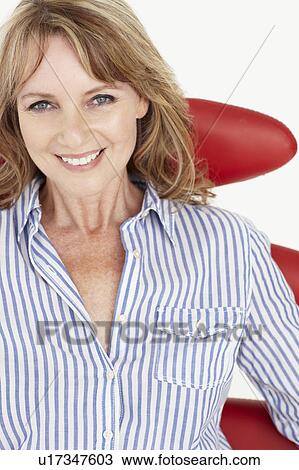Mid age businesswoman relaxing in chair View Large Photo Image Stock Image - Mid age businesswoman relaxing in chair. Fotosearch