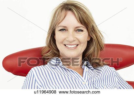 Mid age businesswoman relaxing in chair View Large Photo Image Stock Photo - Mid age businesswoman relaxing in chair. Fotosearch