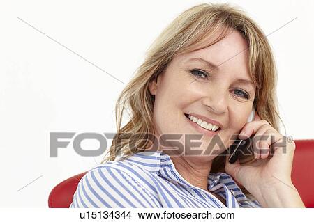 Picture - Mid age businesswoman using cellphone. Fotosearch