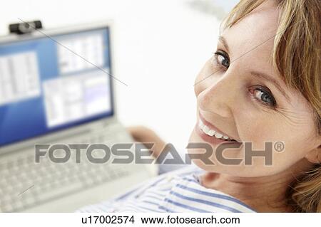 Mid age businesswoman using laptop View Large Photo Image Picture - Mid age businesswoman using laptop. Fotosearch