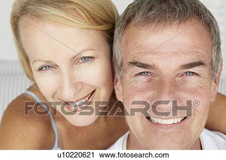 Stock Image - Mid age couple head and shoulders. Fotosearch