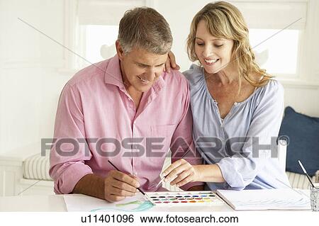 Mid age couple painting with watercolors View Large Photo Image Stock Photograph - Mid age couple painting with watercolors. Fotosearch