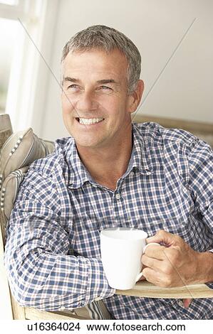 Mid age man at home View Large Photo Image Picture - Mid age man at home. Fotosearch