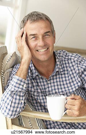 Picture - Mid age man at home. Fotosearch