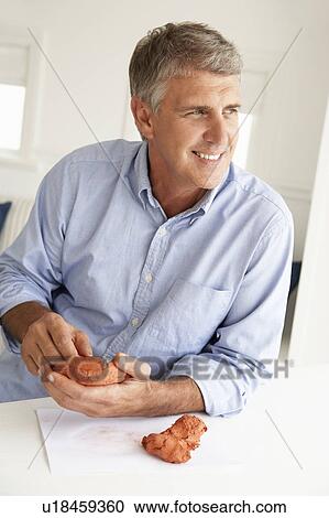 Mid age man clay modelling View Large Photo Image Stock Image - Mid age man clay modelling. Fotosearch