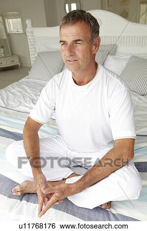 Stock Photograph - Mid age man in lotus position. Fotosearch